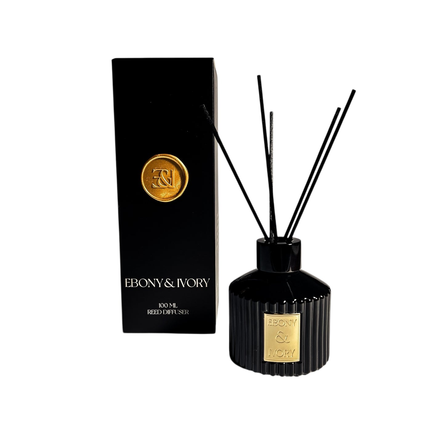A black ribbed 100ml reed diffuser with a gold Ebony & Ivory label next to a black box with a gold wax seal, on a white background, made by Ebony & Ivory Candle Co in Lethbridge, Alberta, Canada