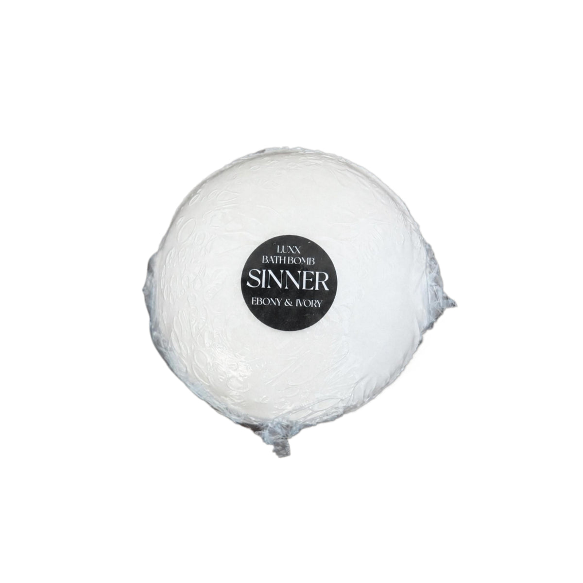 A luxury bath bomb with a black label named "sinner"