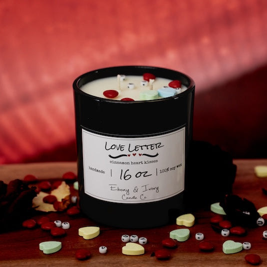 Candle with decorative elements on a wooden surface. soy candle Canada. Cinnamon heart candy candle for valentines day.