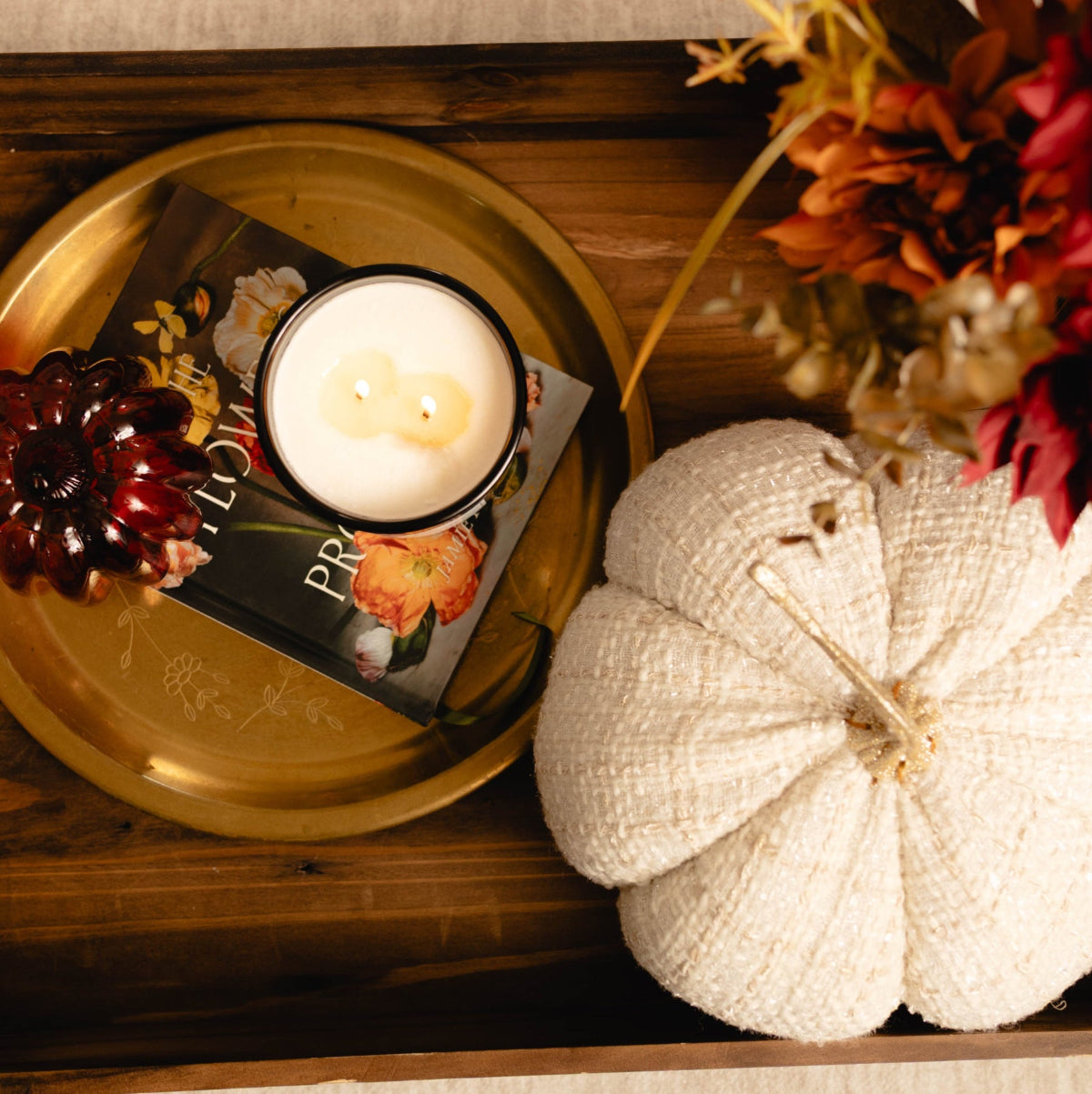 Decorative tray with a candle, pumpkin, and fall-themed decor on a textured surface. Pumpkin Spice soy fall candle Alberta Canada.