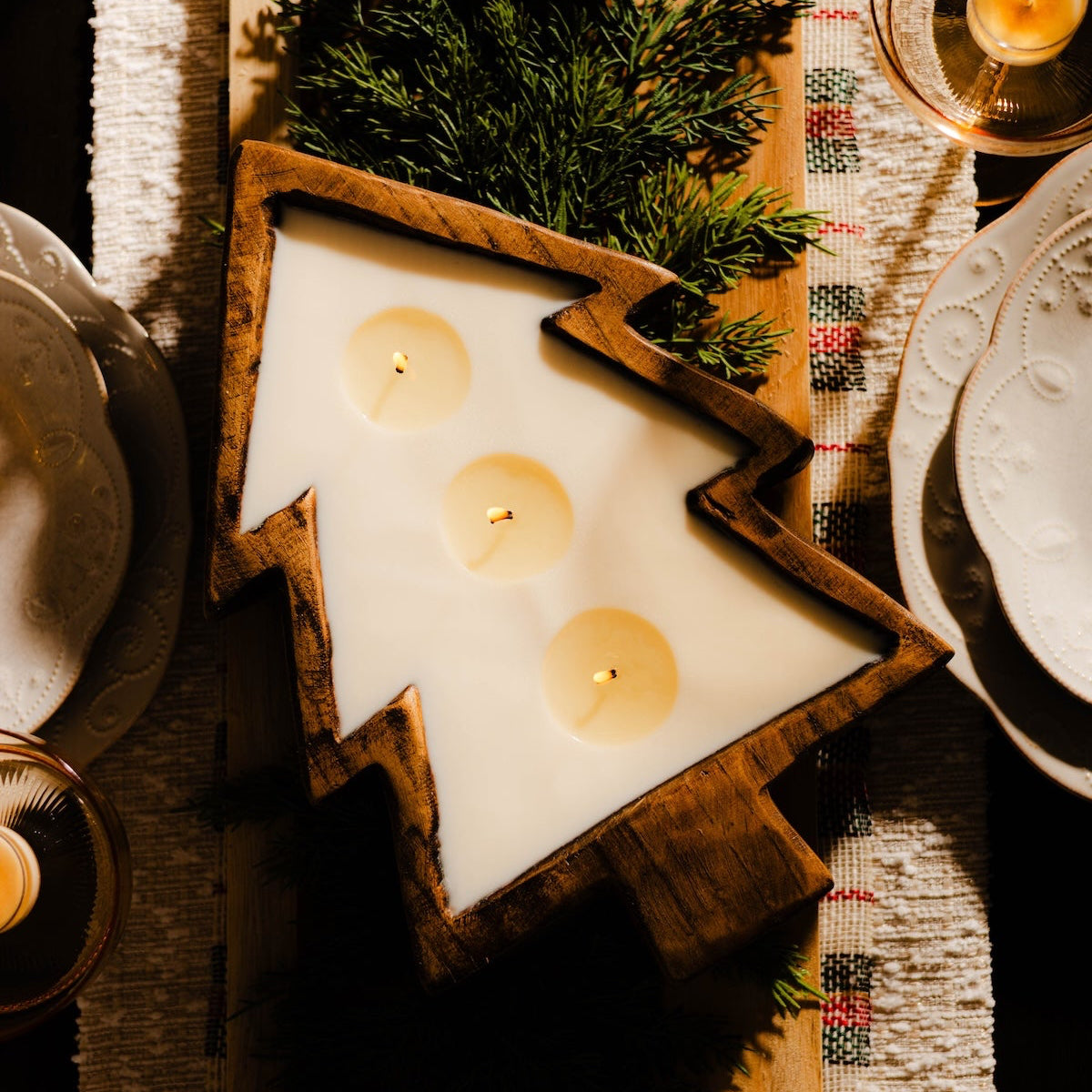 A Christmas candle in a wooden dough bowl that's in the shape of a tree. Unique Christmas gift.
