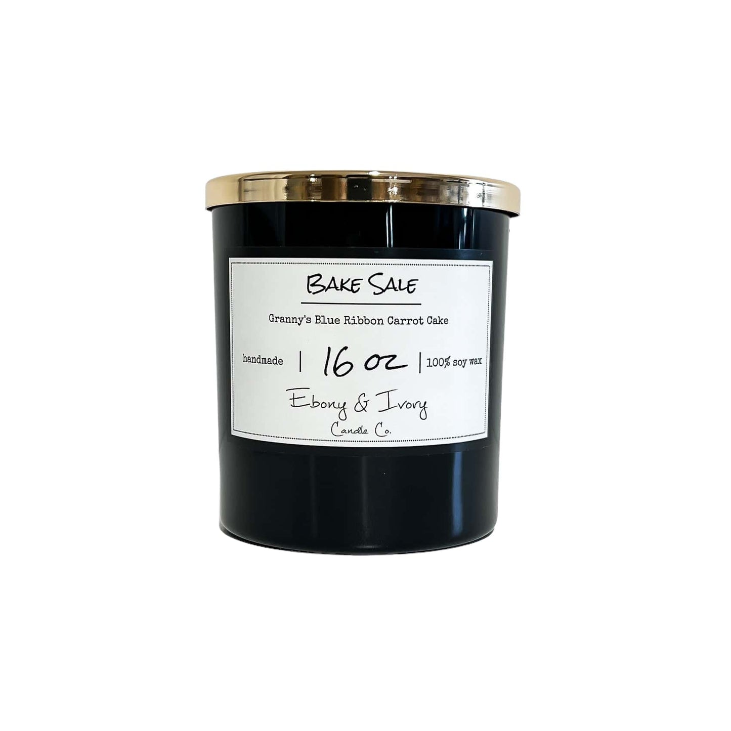 Black, sixteen ounce, spicy carrot cake and cream cheese frosting scented soy wax candle with a white label that reads Bake Sale