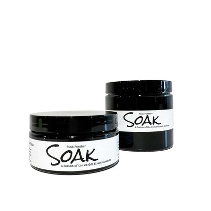 a 4oz and an 8oz round black jars with a white label named Pink Panther Clay Soak, on a white background, made by Ebony & Ivory Candle Co in Lethbridge, Alberta, Canada