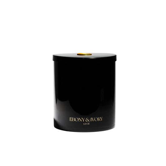 A large 64oz black jar soy candle with gold lettering and a gold wax seal on the lid, on a white background, made by Ebony & Ivory Candle Co in Lethbridge, Alberta, Canada