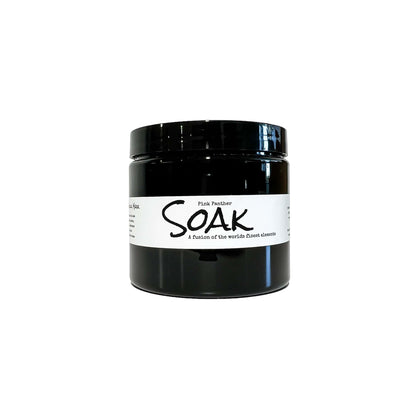 An 8oz round black jar with a white label named Pink Panther Clay Soak, on a white background, made by Ebony & Ivory Candle Co in Lethbridge, Alberta, Canada