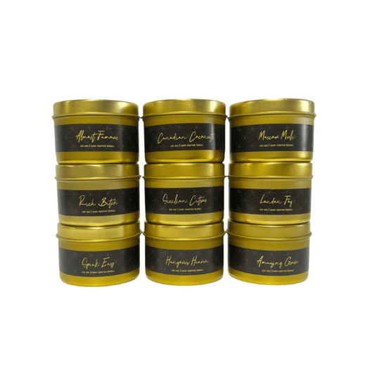A set of 9 gold 4oz tin soy candles stacked together with black labels on a white background, made by Ebony & Ivory Candle Co in Lethbridge, Alberta, Canada