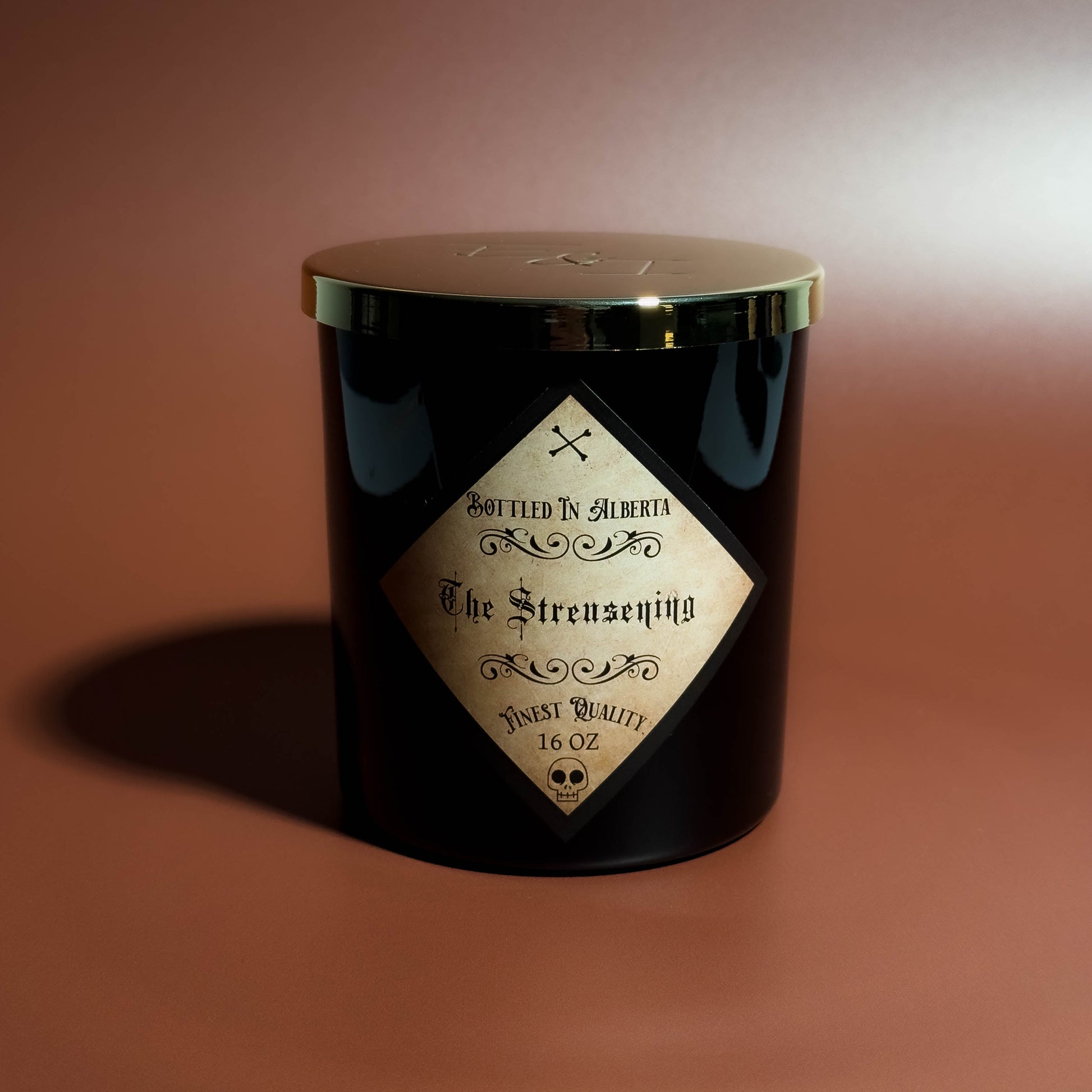 Black candle jar with a label on a brown background