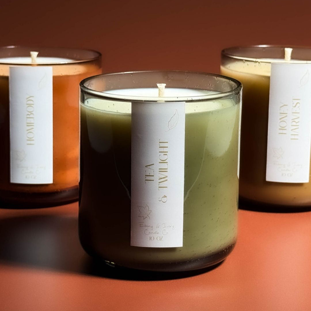 Three candles with labels on a warm-toned background