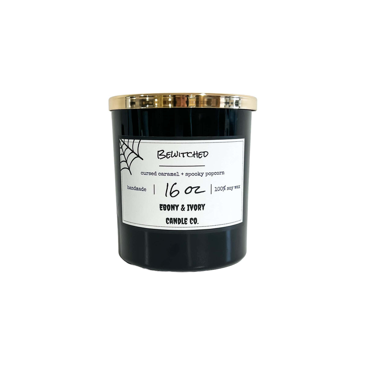 A black 16oz soy candle with a gold lid a white label with cobwebs, named "bewitched," on a white background
