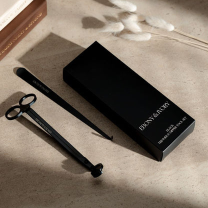 A black box for a set of 2 candle tools. The tools are a black wick trimmer and a black wick dipper with white Ebony & Ivory logos