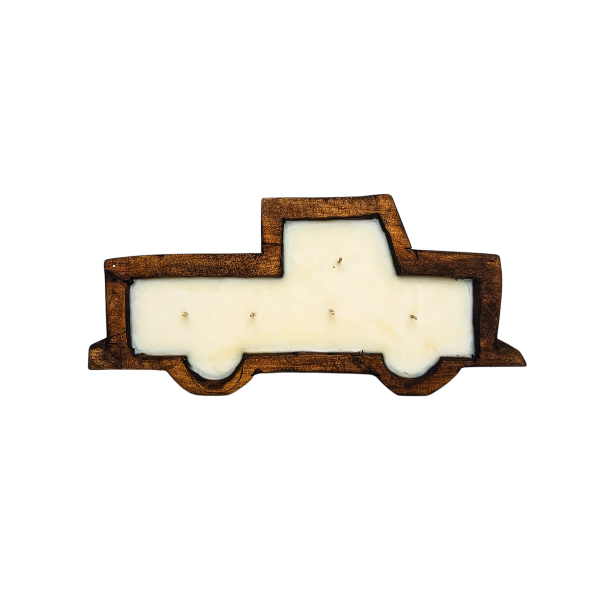 A brown wooden dough bowl candle in the shape of a pickup truck.