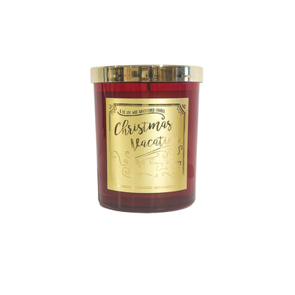 A red 8oz soy christmas candle with a gold lid and a gold label named "christmas vacation"