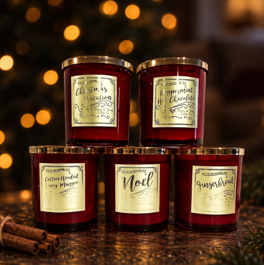 red jar christmas candles with gold lids and gold labels. 