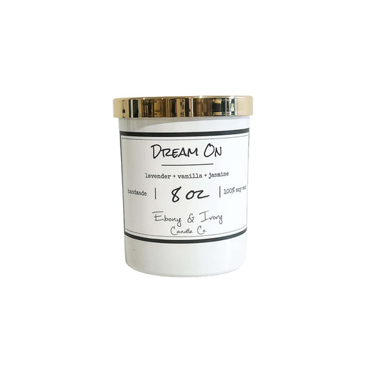A white 8oz jar soy candle with a gold lid and a white label named Dream On, on a white background, made by Ebony & Ivory Candle Co in Lethbridge, Alberta, Canada