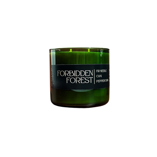 Green candle labeled 'Forbidden Forest' on a white background