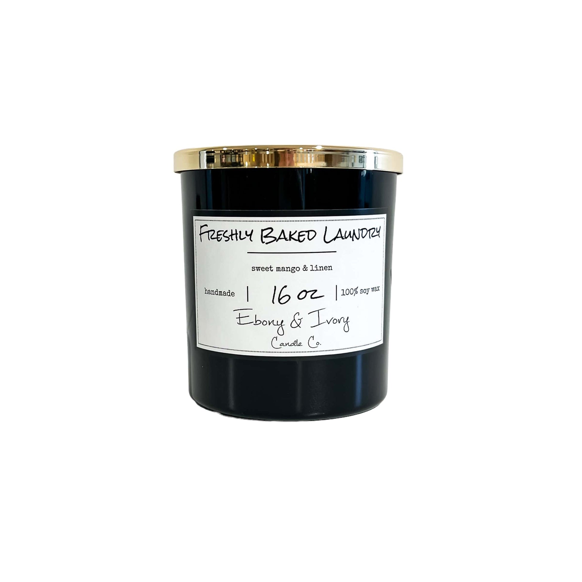 A black 16oz soy candle with a gold lid and a white label named "Freshly Baked Laundry" 