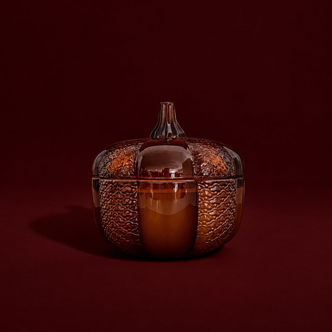 An 8oz soy wood wick soy candle in an amber heirloom pumpkin jar.
