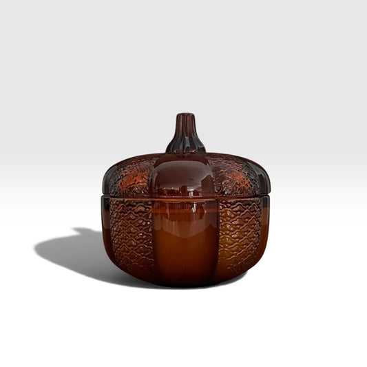 An 8oz soy wood wick soy candle in an amber heirloom pumpkin jar.