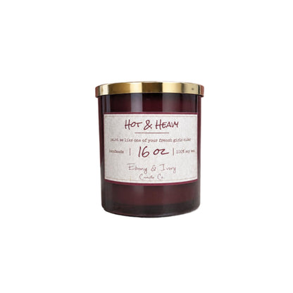A 16oz amber jar 16oz soy candle with a gold lid and a label named "Hot & Heavy" on a white background
