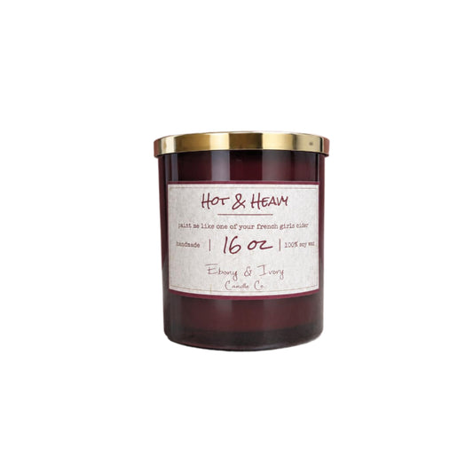A 16oz amber jar 16oz soy candle with a gold lid and a label named "Hot & Heavy" on a white background
