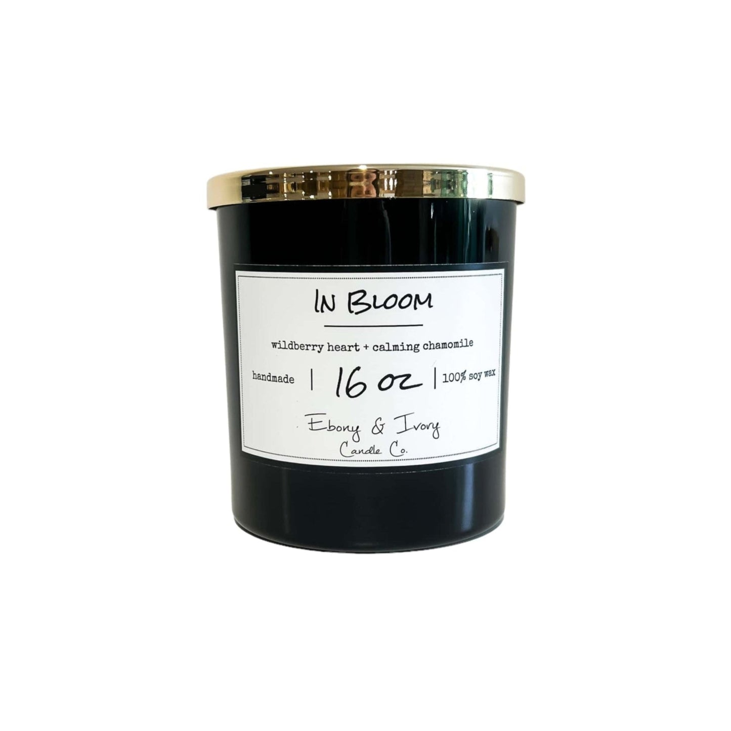 A black 16oz jar soy candle with a gold lid and a white label named In Bloom, on a white background, made by Ebony & Ivory Candle Co in Lethbridge, Alberta, Canada