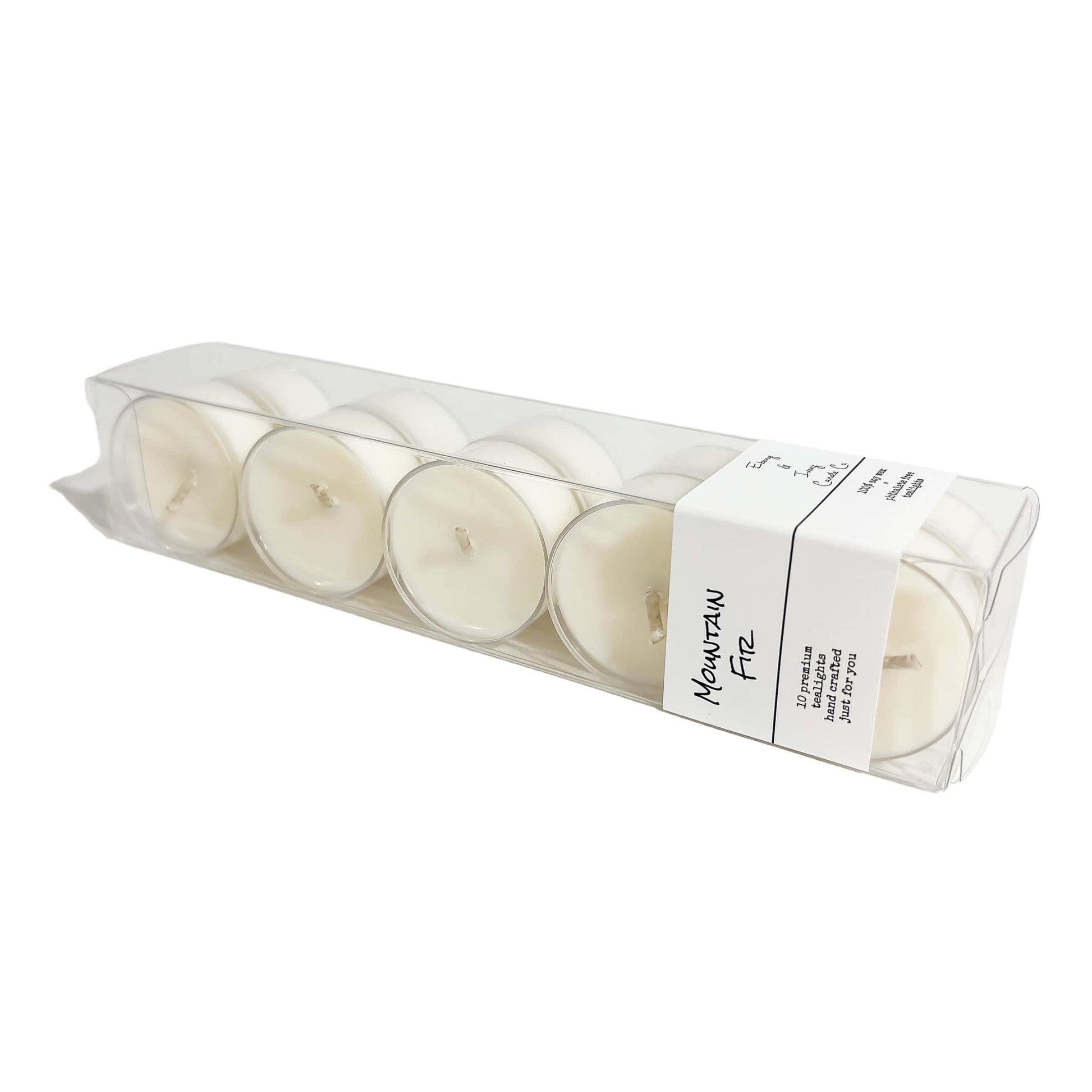 A clear box of 10 soy tea lights with a white label named Mountain Fir, on a white background, made by Ebony & Ivory Candle Co in Lethbridge, Alberta, Canada