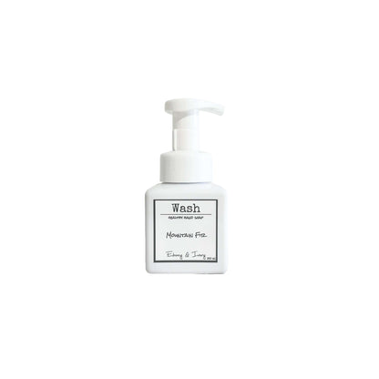 A white pump bottle of foaming hand soap with a white label named Mountain Fir, on a white background, made by Ebony & Ivory Candle Co in Lethbridge, Alberta, Canada