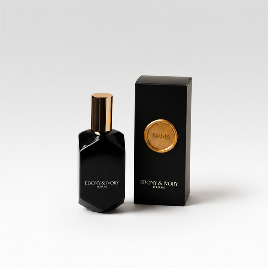A black perfume bottle with a gold lid on a white background, next to a black box with a gold wax seal labelled Naria. Made in Lethbridge Alberta Canada