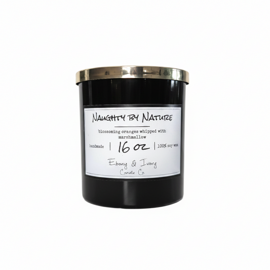 A black 16oz soy candle with a gold lid, labelled Naughty by Nature, on a white background. Made in lethbridge, alberta, canada