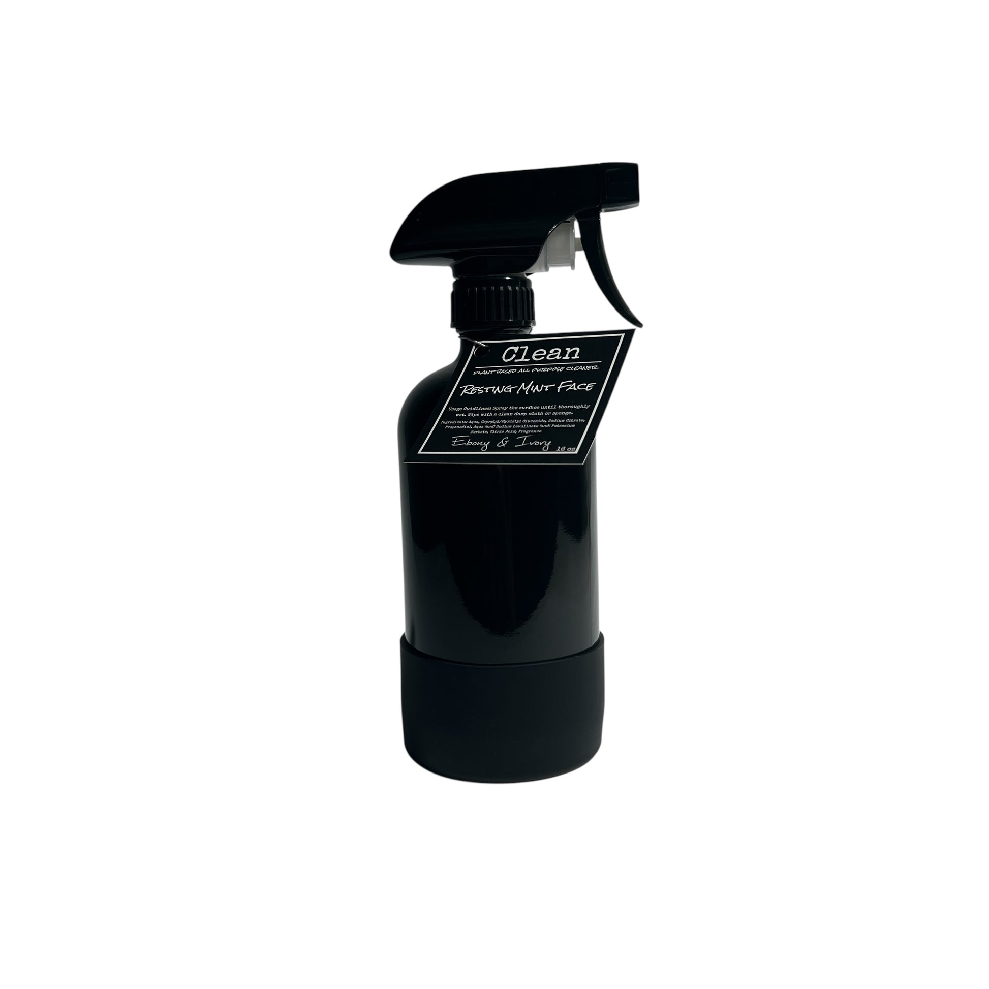 A 16oz black sprayer bottle of all purpose cleaner with a rubber bottom and a black label that reads "Resting Mint Face" on a white background, made by Ebony & Ivory Candle Co in Lethbridge, Alberta, Canada