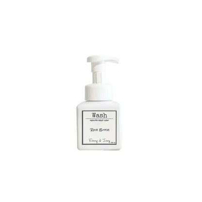 A white pump bottle of foaming hand soap with a white label named Rich Bitch, on a white background, made by Ebony & Ivory Candle Co in Lethbridge, Alberta, Canada
