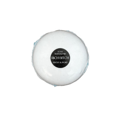 A luxury bath bomb with a black label named "Rich Bitch"