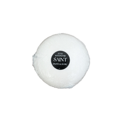 A white luxury bath bomb with a black label named "saint"