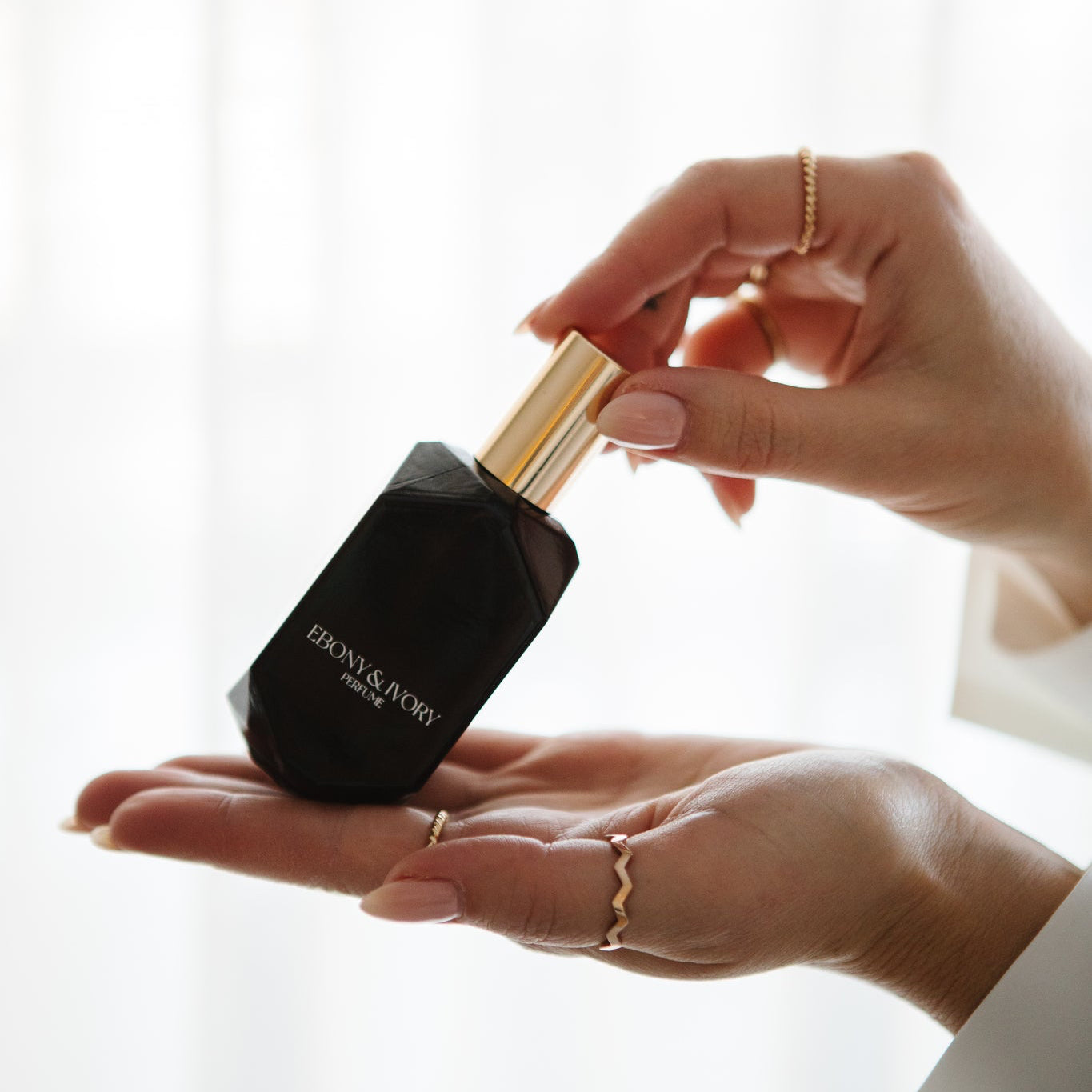 Woman holding Saint perfume warm sensual gourmand fragrance