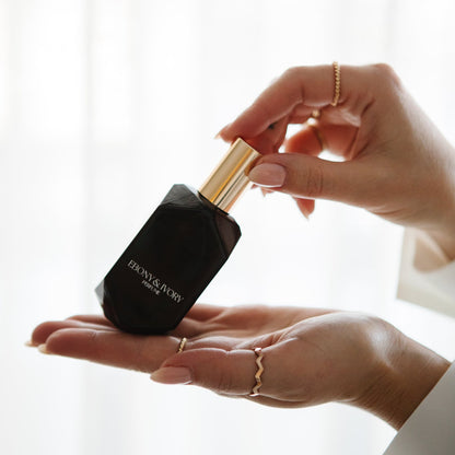 Woman holding Saint perfume warm sensual gourmand fragrance