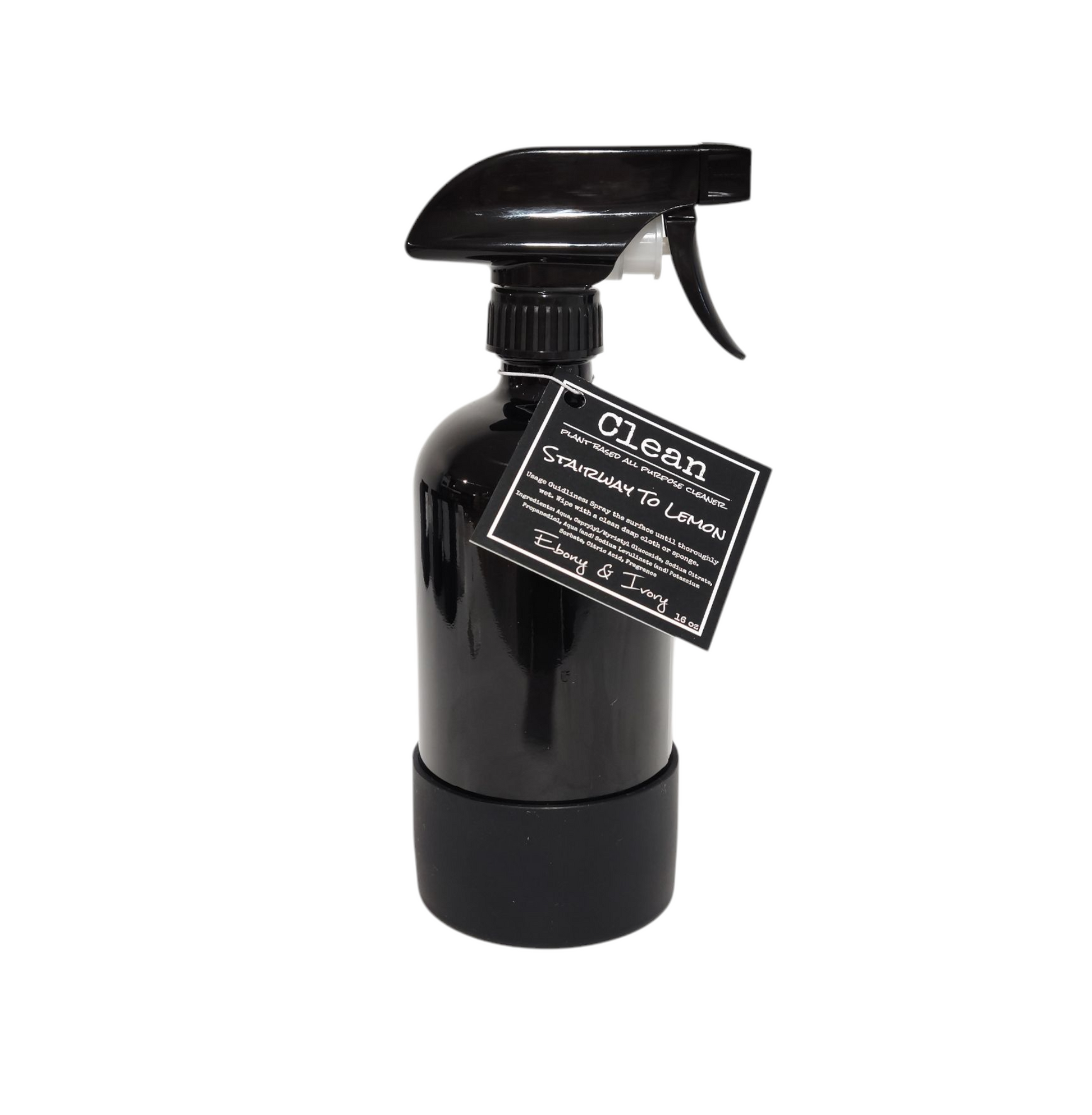 A 16oz black sprayer bottle of all purpose cleaner with a rubber bottom and a black label that reads "Stairway to Lemon" on a white background, made by Ebony & Ivory Candle Co in Lethbridge, Alberta, Canada