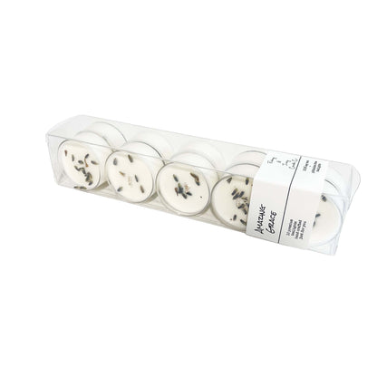A clear box of 10 soy tea lights with a white label and dried lavender buds on top named Amazing Grace, on a white background, made by Ebony & Ivory Candle Co in Lethbridge, Alberta, Canada