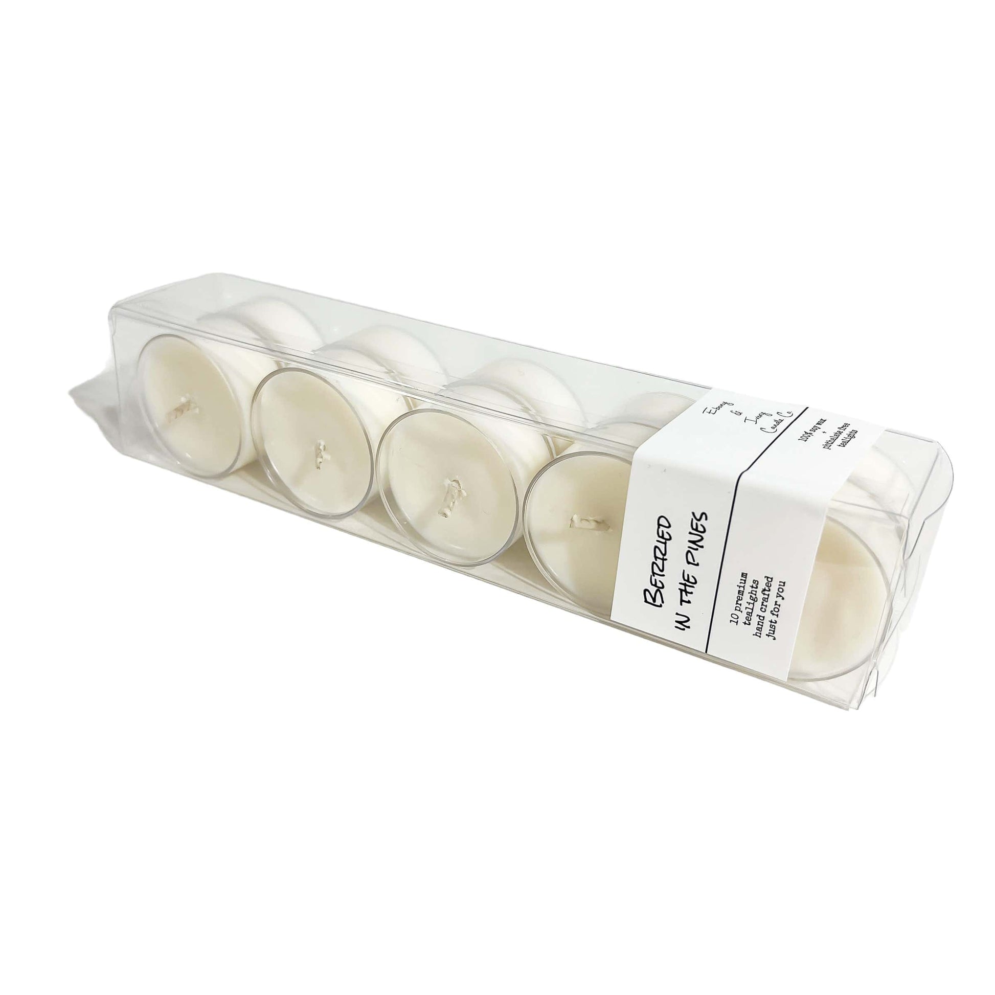 A clear box of 10 tea lights with a white label named Berried in the Pines, on a white background, made by Ebony & Ivory Candle Co in Lethbridge, Alberta, Canada