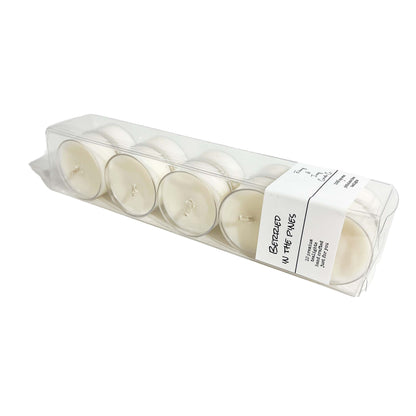 A clear box of 10 tea lights with a white label named Berried in the Pines, on a white background, made by Ebony & Ivory Candle Co in Lethbridge, Alberta, Canada