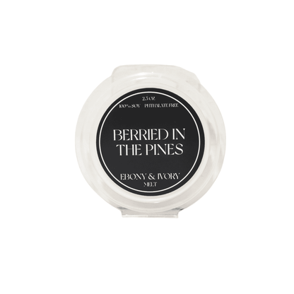 A clear clam shell soy wax melt with a black label named Berried in the Pines, on a white background, made by Ebony & Ivory Candle Co in Lethbridge, Alberta, Canada