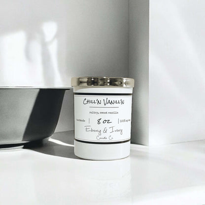 white 8oz jar soy candle with a gold lid and a white label named Chill'n Vanill'n, on a white counter with a grey bowl beside it, made by ebony & ivory candle co, in lethbridge, alberta, canada