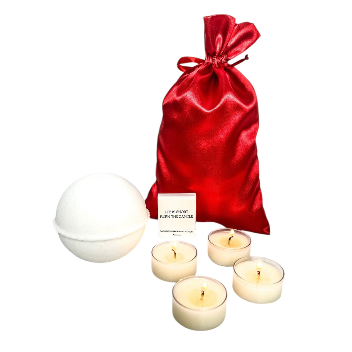 A bath bomb, four tea lights, a book of ebony & ivory candle co matches, and a red satin bag for a christmas bath buddy kit