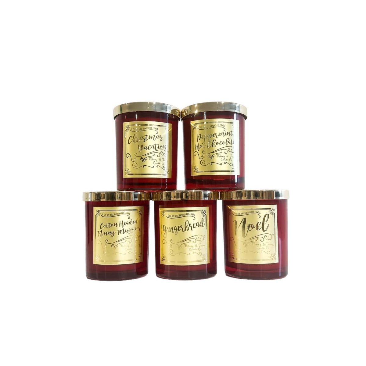 A stack of red 8oz soy christmas candles with gold lids and gold labels.