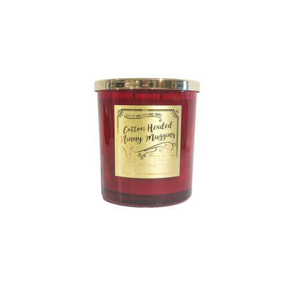 A red 16oz soy christmas candle with a gold lid and a gold label named "cotton headed ninny muggins"