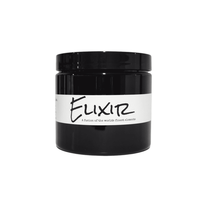 A round 16oz black container with a white label named Elixir that contains pink Himalayan salt, dead sea salt, epsom salt, and peppermint essential oils. Made by ebony & Ivory candle co in Lethbridge, Alberta, Canada