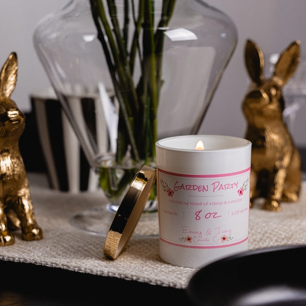 Candle with a rabbit design on a decorative table setting. a easter table decor setting with best soy candle canada.

