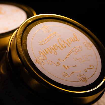 A gold 4oz soy candle with a white and gold label named "gingerbread"