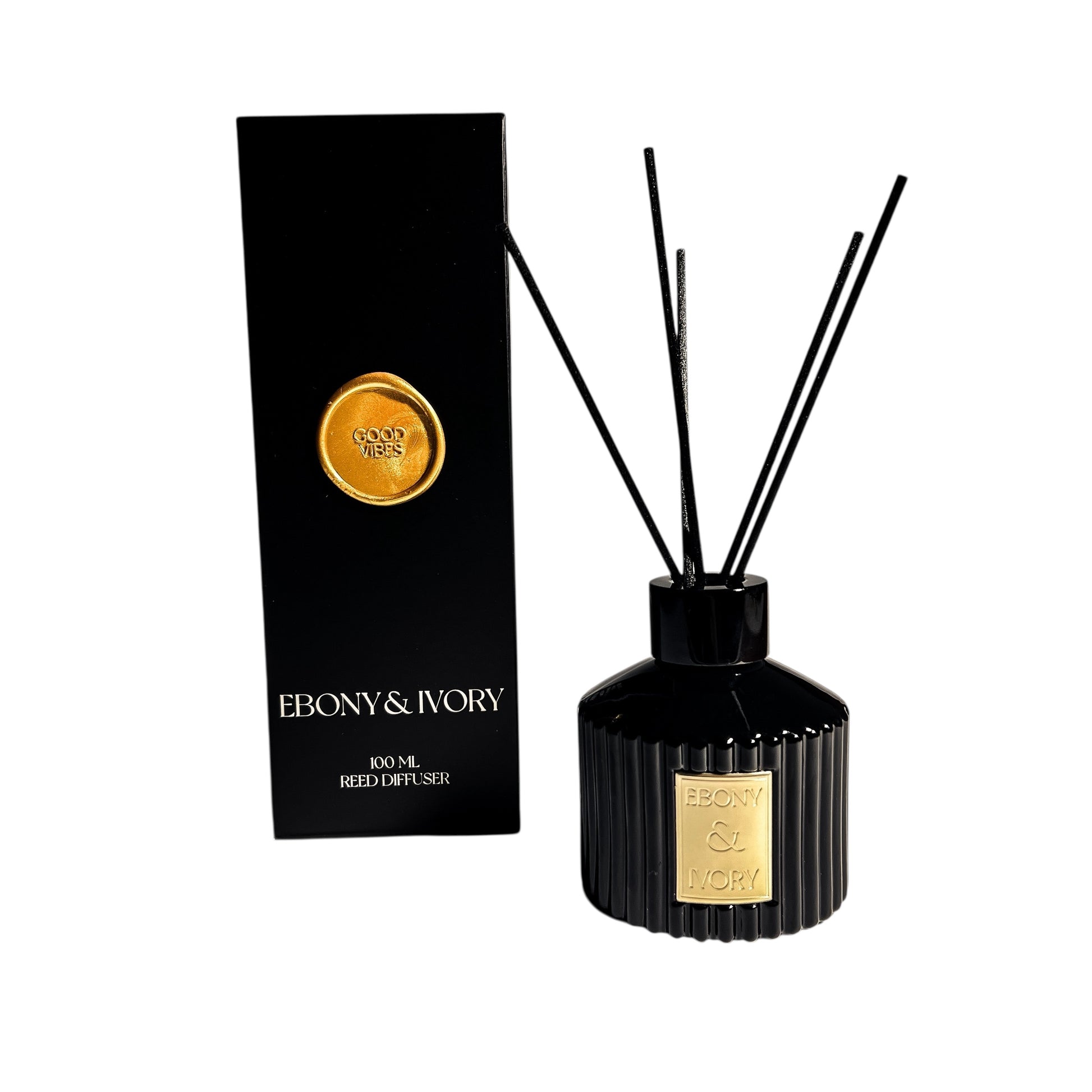 A black ribbed 100ml reed diffuser with a black box with a gold wax seal named Good Vibes, on a white background, made by Ebony & Ivory Candle Co in Lethbridge, Alberta, Canada