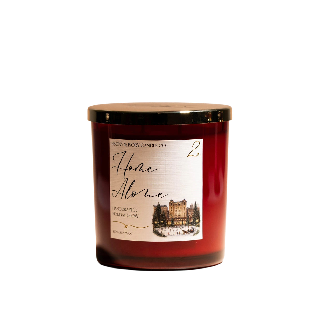 A red 16oz soy christmas candle with a gold lid and a white label named "home alone 2"