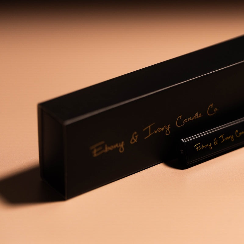 Black rectangular candle box with 'Ebony & Ivory Candle Co.' branding on a beige background. black and gold usb lighter
